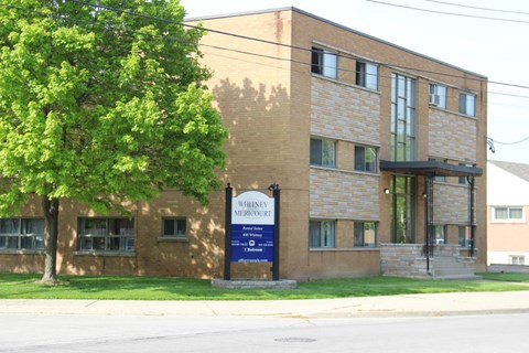 A brick building with a sign that says Whiskey Mercure.