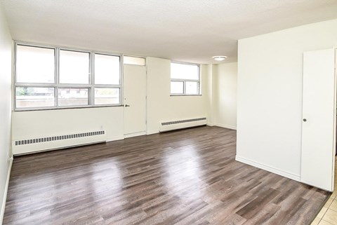 A room with wooden floors and white walls.