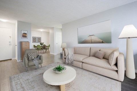 A living room with a couch, chair, and a coffee table.