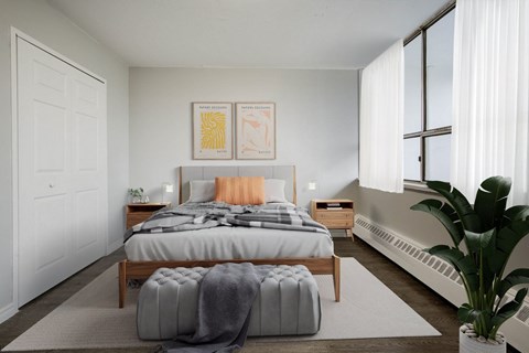 A bedroom with a large bed and a plant.