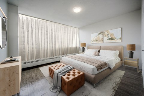 A bedroom with a large bed, a bench, and a painting on the wall.