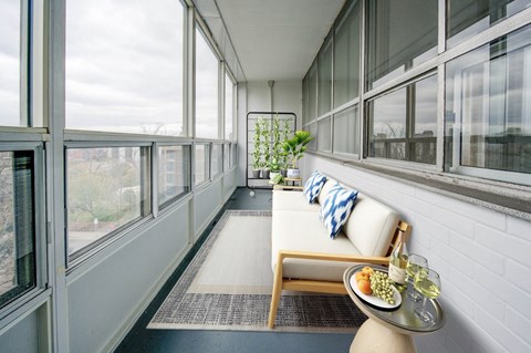 A table with food and drinks on it in front of a window.