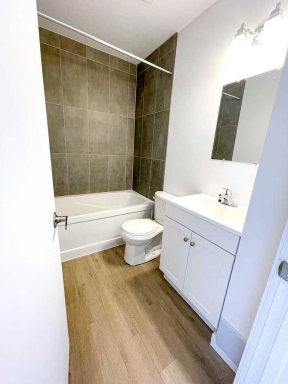 A white bathroom with a toilet, sink, and bathtub.