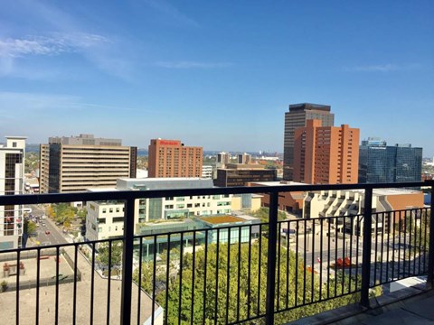 A cityscape with buildings of various heights and a clear blue sky.