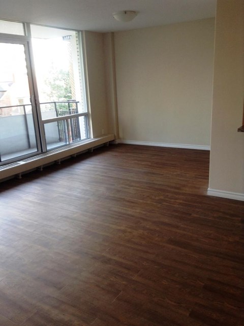 A room with wooden floors and a window.