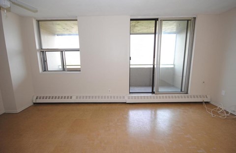 A room with a window and a sliding glass door.