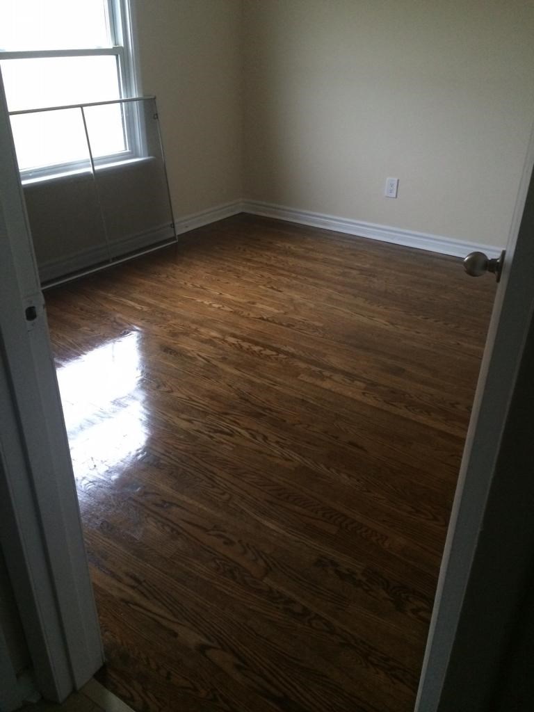 A room with wood flooring and a window.