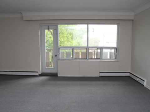 A room with a large window and a door.