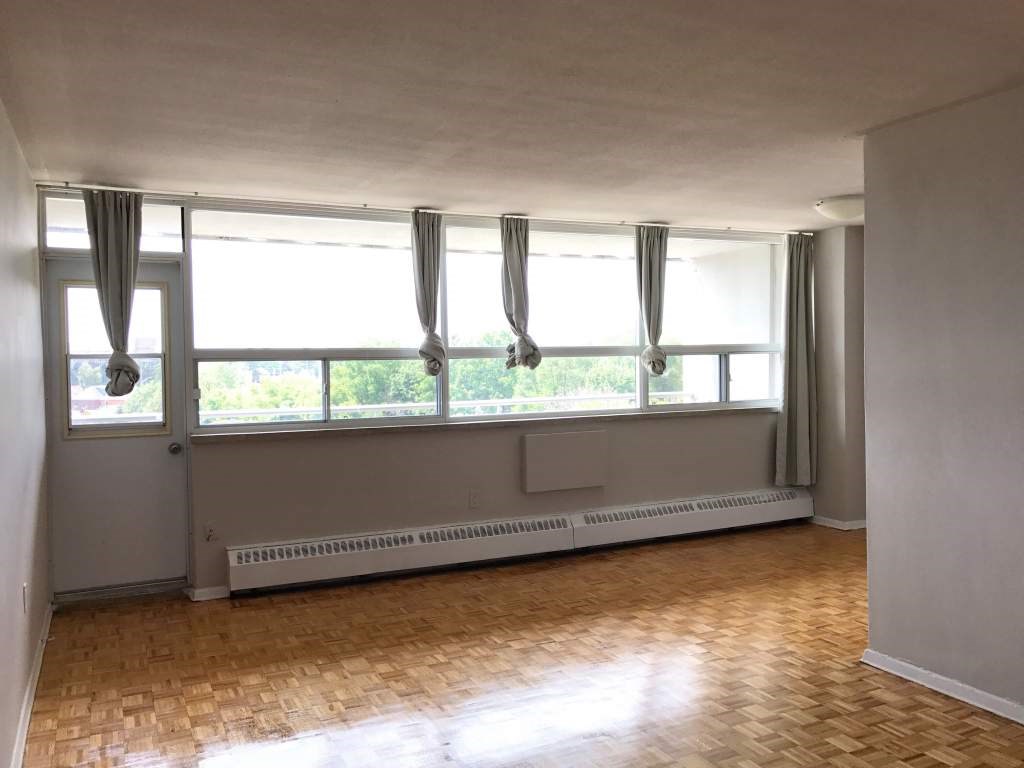 A room with a window and a radiator on the wall.