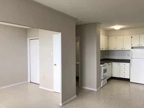A kitchen with white appliances and cabinets is shown.