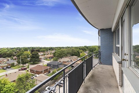 A balcony overlooks a residential neighborhood.