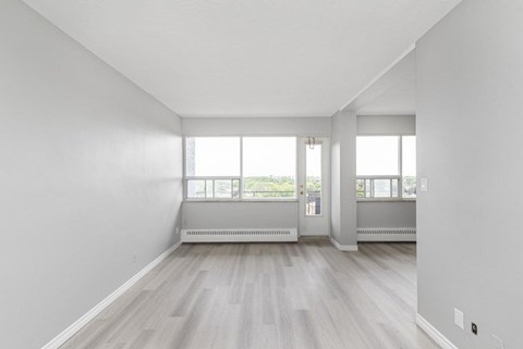 A room with a window and a radiator on the floor.