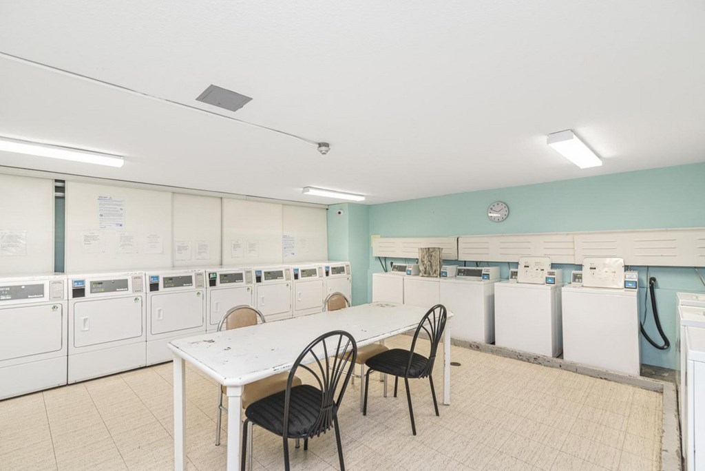 A laundry room with a table and chairs.