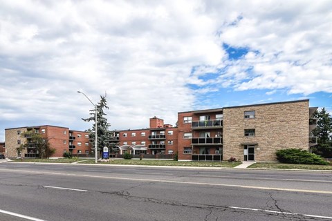 A street view of a residential area with apartment buildings.