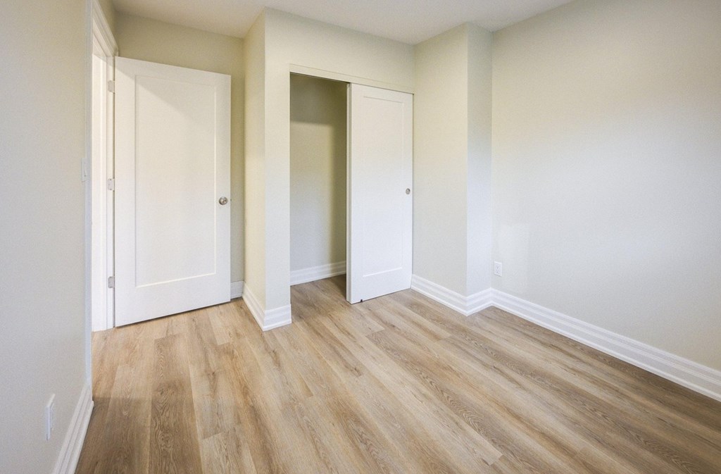 A room with two doors and a wooden floor.
