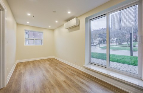 A room with a window and a sliding glass door.