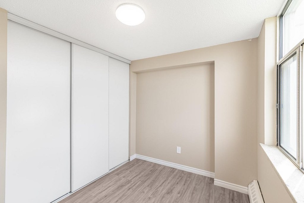 A room with a sliding door and a window.