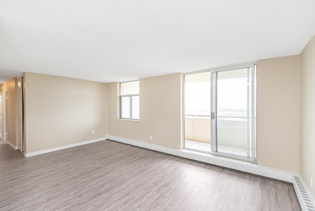 A room with a sliding glass door and a window.