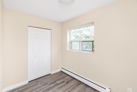 A room with a white door and a window with a white frame.