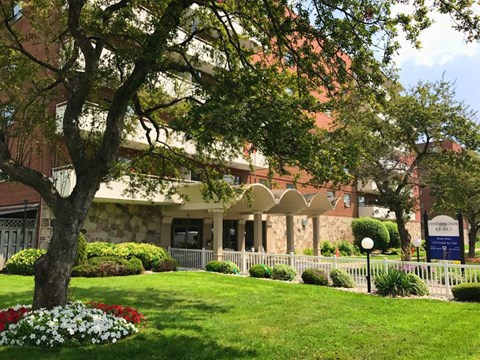 A building with a white fence and a sign that says "Campus".