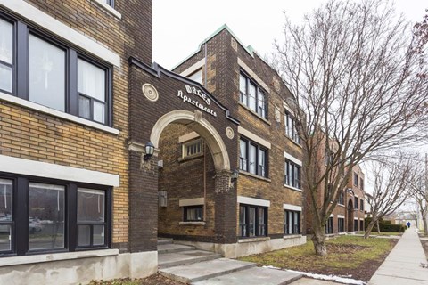 A brick building with a sign that says "West Side Apartments".