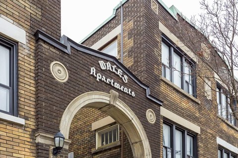 A brick building with a sign that says "Walnut Apartments".