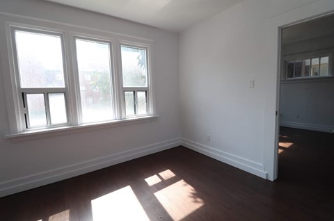 A room with a window and sunlight coming through.