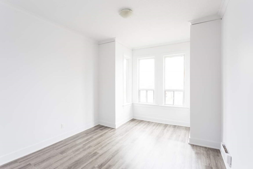A room with a wooden floor and white walls.