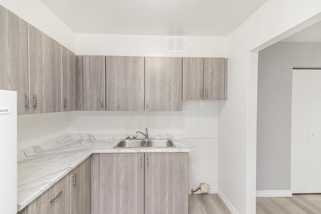A kitchen with wooden cabinets and a white countertop.