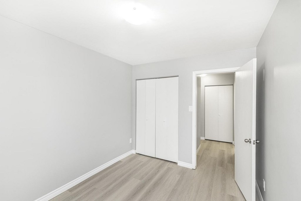 A white room with a door and a window.