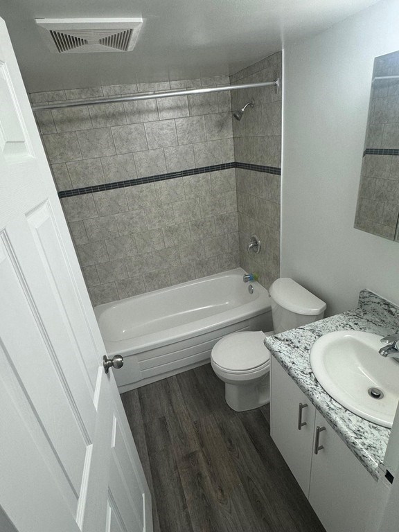 A bathroom with a toilet, sink, and bathtub.