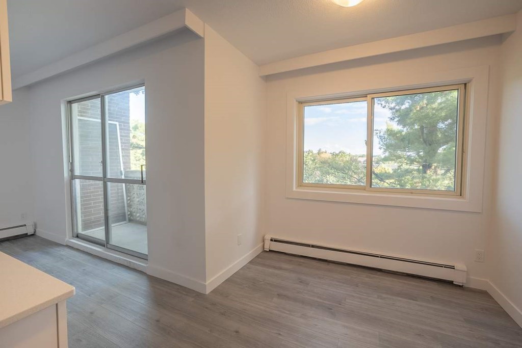 A room with a window and a sliding glass door.