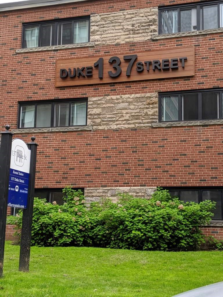 A brick building with a sign that says Duke 137 Street.