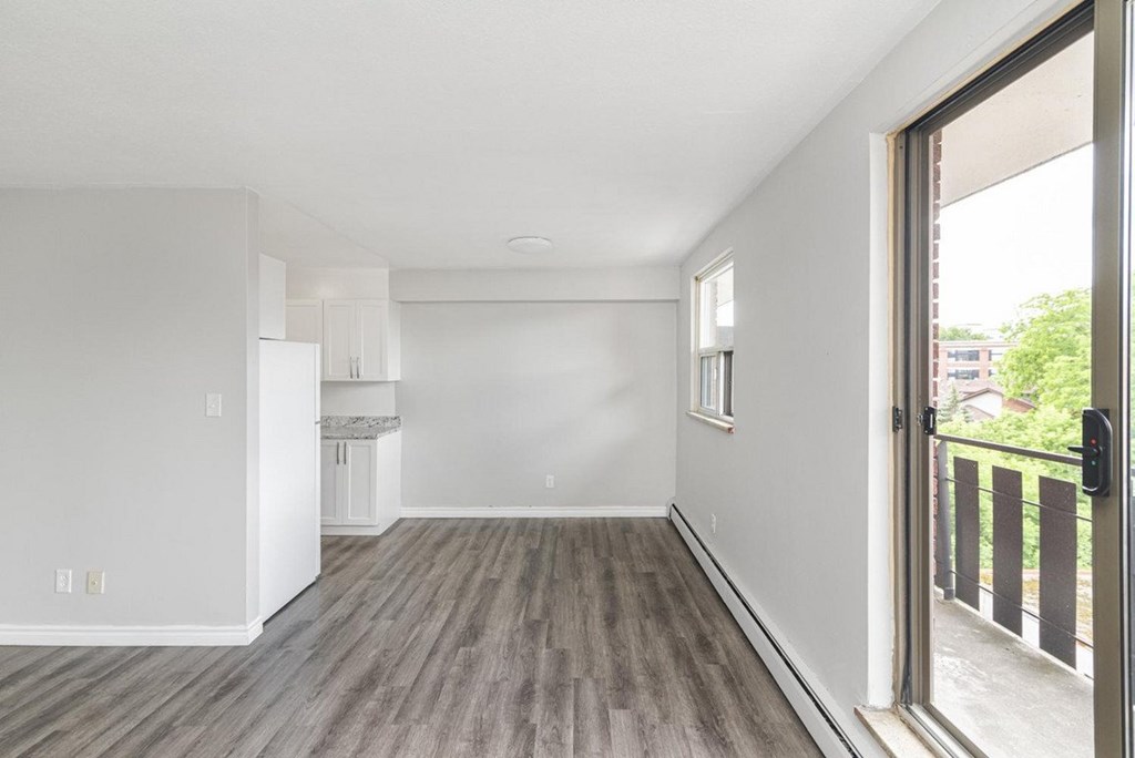 A room with a wooden floor and white walls.