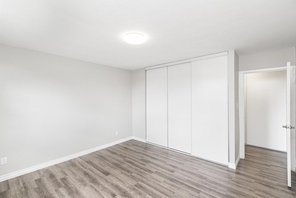 A room with white walls and a wooden floor.