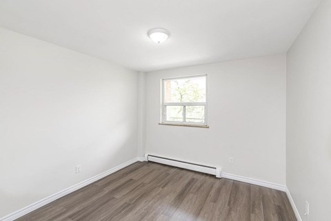 A room with a window and a white ceiling.