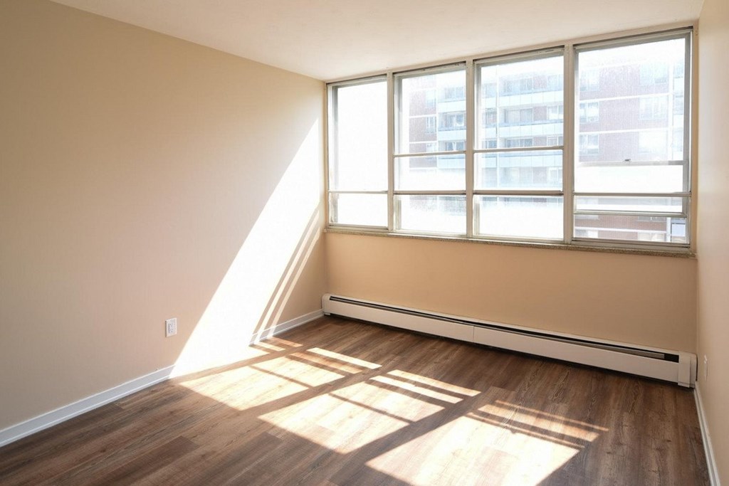 A room with a window and a radiator on the wall.