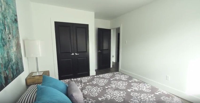 A bedroom with a bed and a dresser.