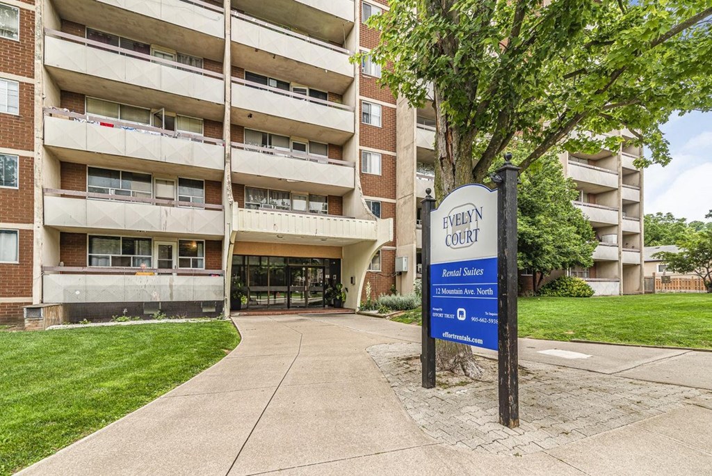 A sign for Evelyn Court is in front of a building.