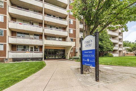 A sign for Evelyn Court is in front of a building.