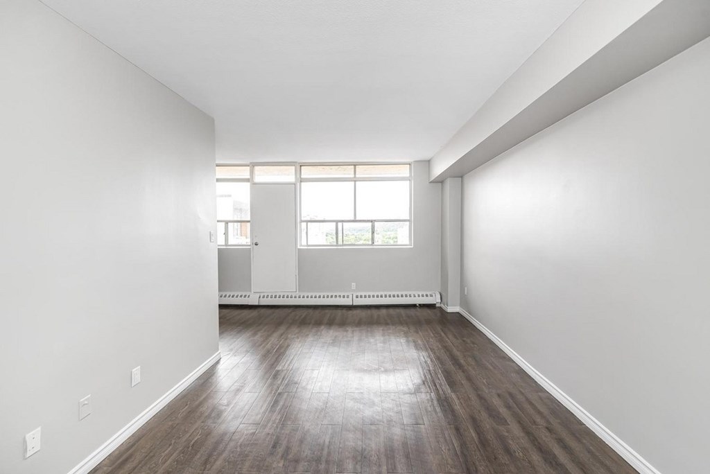 A room with wooden floors and white walls.
