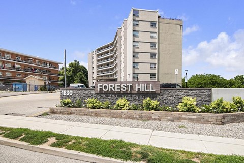 A modern building with the name "FOREST HILL" on it.