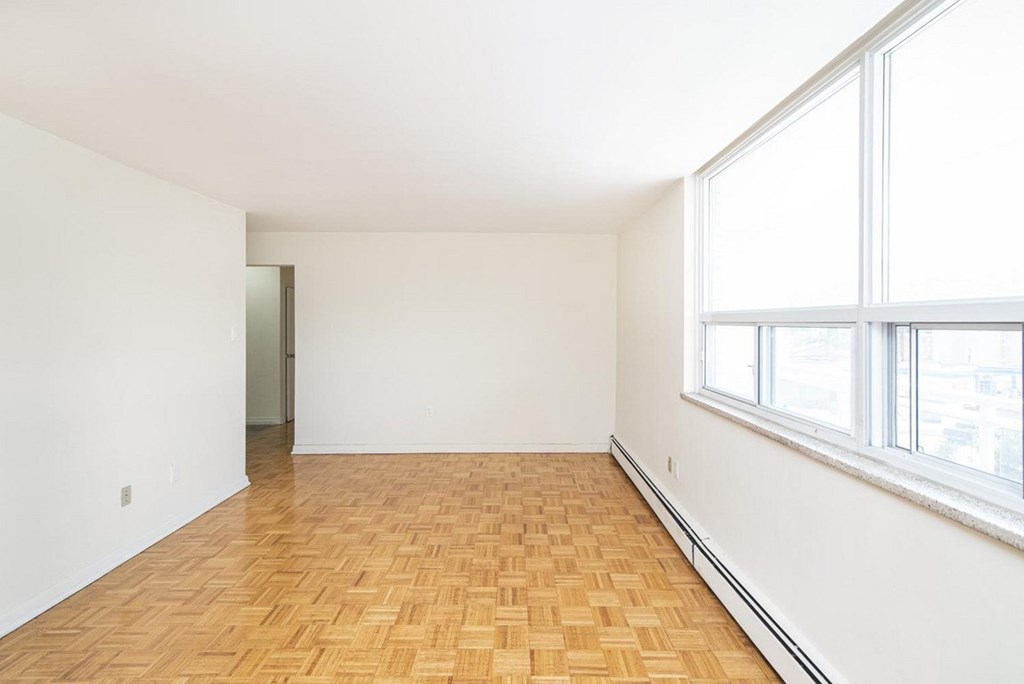 A room with a wooden floor and a window.