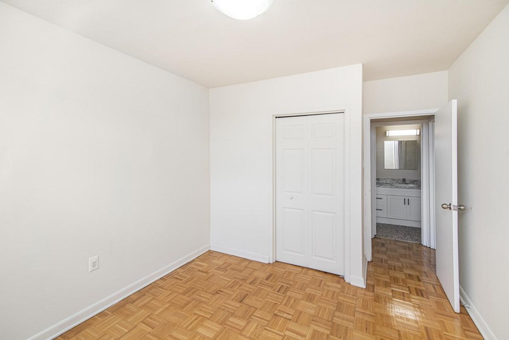 A room with a wooden floor and a white door.