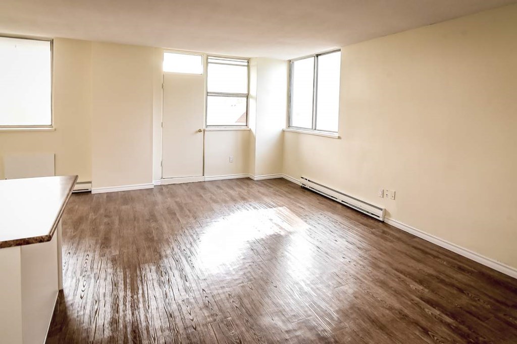 A room with wooden floors and white walls.