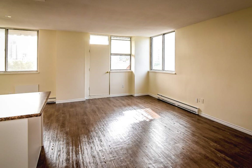 A room with wooden floors and white walls.