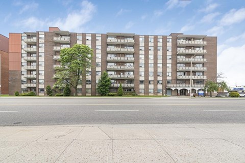 A large brick building with many windows and balconies.