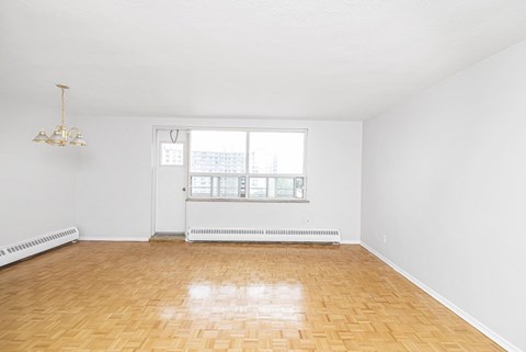 A room with a wooden floor and a chandelier.