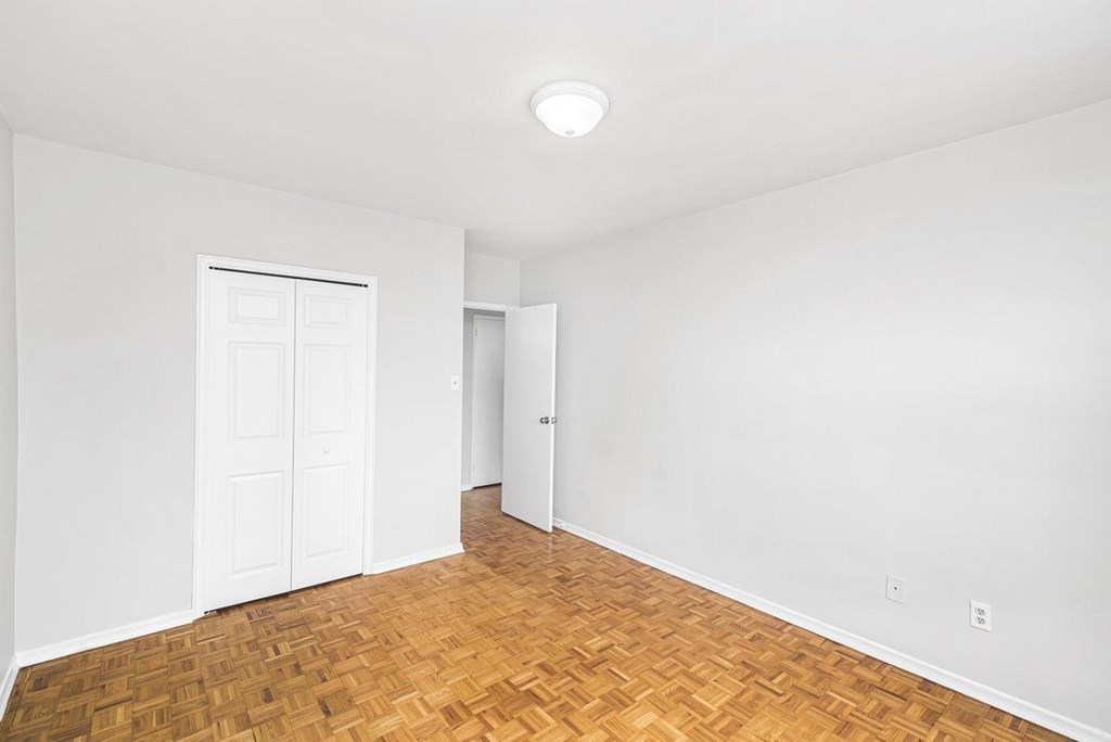 A room with a wooden floor and white walls.