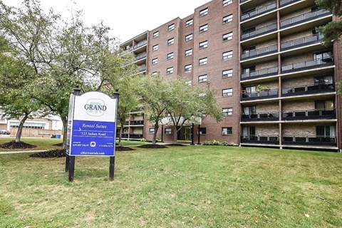 A sign in front of a building that says Grand Renewal Suites.